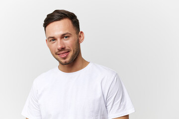 Cheerful cute happy young tanned handsome man in basic t-shirt smile at camera posing isolated on over white studio background. Copy space Banner Mockup. People emotions Lifestyle concept. Portrait