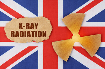 On the flag of Great Britain, the symbol of radioactivity and torn cardboard with the inscription - X-Ray Radiation