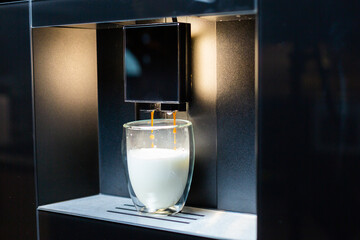 Close-up. Preparation of coffee latte in a modern coffee machine.