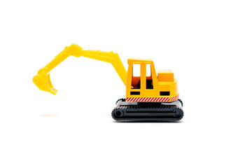 Colorful little mini yellow plastic tractor excavator, truck, lorry, car toy isolated on white background mockup with copy space, toys for children, kids development, playing, childhood fun