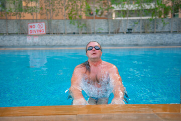 one swimmer in goggles swims in a large pool