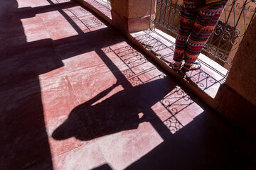 A woman and her shadow in a historic building in Morocco