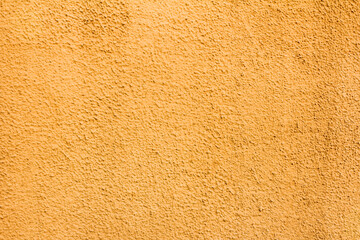 Texture of yellow embossed yellow plaster