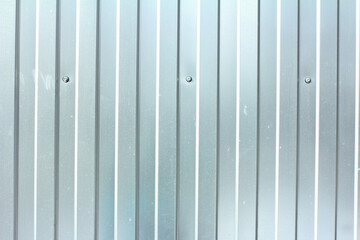 Fototapeta premium Gray corrugated steel fence, metal profiled sheet texture 