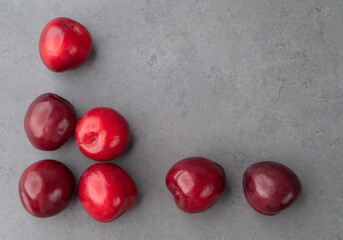 A group of plums over stone background with copy space