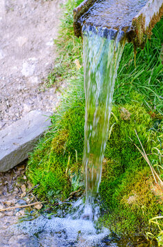 Falling stream of fresh clean spring water. Energy of nature. © romankrykh