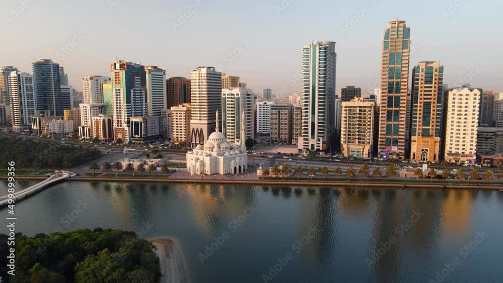 Wall mural Sharjah aerial view above Al Noor island and mosque and downtown rising above Khalid lake