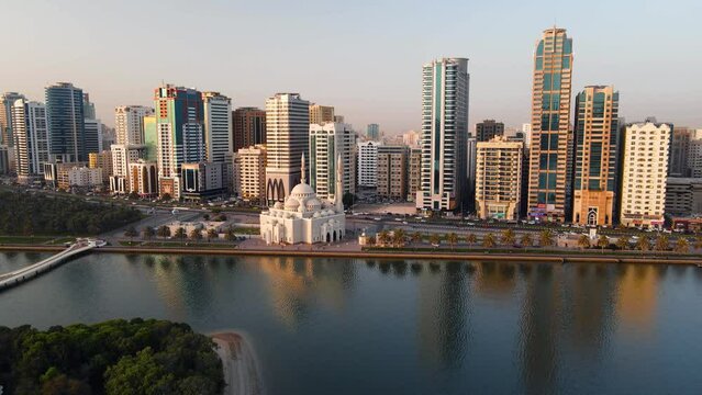 Sharjah aerial view above Al Noor island and mosque and downtown rising above Khalid lake