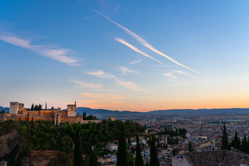 Views of the city of Granada, the Alhambra and the Sierra Nevada mountains at sunset