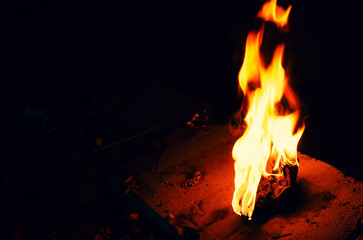 Bright fire torch on a dark background. White yellow red flame.