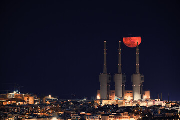 Blood moon over the three chimneys of the Sant Adrià del Besòs thermal power plant (Barcelona, Spain)