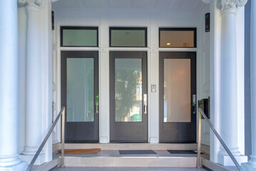 Three black front doors with glass panels and transom windows at San Francisco, California - obrazy, fototapety, plakaty