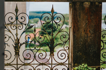 Fototapeta na wymiar Vintage wrought iron pattern. Part of the old balcony. Ancient architecture.