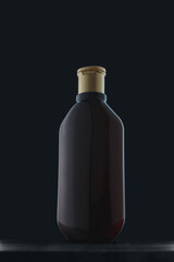 Shampoo, hair conditioner or washing gel bottle on black background. Care cosmetics mock up, dark no brand template. Copy space, vertical shot