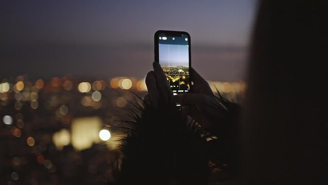 Close up shot of woman blogger making photos of night city lights, enjoying vacation, tracking shot, empty space
