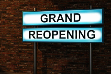 Obraz premium Grand reopening. Black letters on a light box. The illuminated sign placed in front of a brick wall. Opening, new start and new business concept. 3D illustration