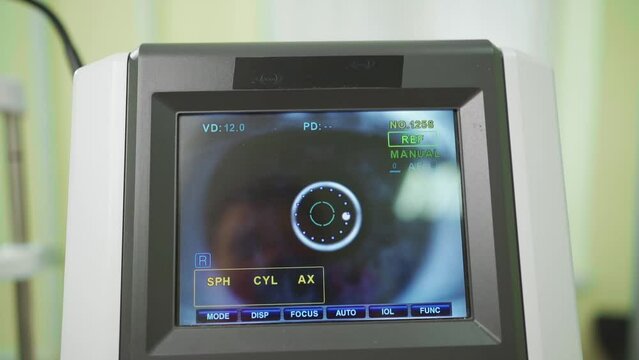 eye on the screen of the autorefractometer. a modern ophthalmic device.