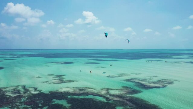 People learning kitesurf in a beautiful lagoon on Paje Beach on the island of Zanzibar, famous touristic destination for water sports