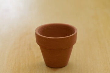 A clean, empty plant pot sits waiting to be filled with potting mix and a plant.