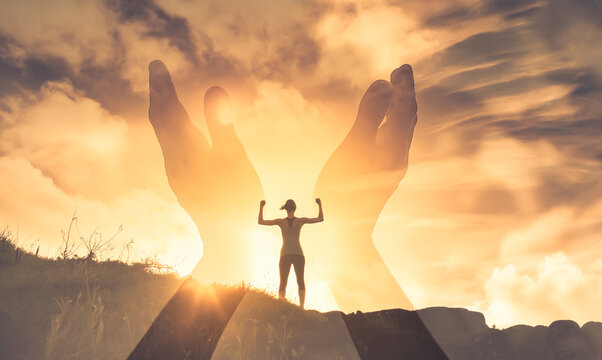 People finding inner strength, freedom, and hope. Strong woman on a mountain top with arms up to the sunrise 