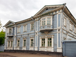 Fototapeta na wymiar Facade of wooden house of Decembrist Sergei Volkonsky in Irkutsk in summer in cloudy weather.