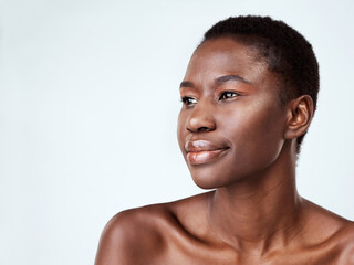Fototapeta premium Shes proof that perfect skin is possible. Studio shot of a beautiful young woman looking thoughtful against a grey background.