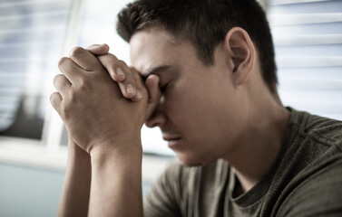 Young man saying a prayer 