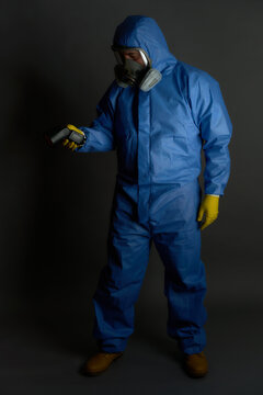 anti radioactive chemical suit with gas mask gloves on gray background and dramatic detector
