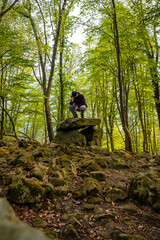 A man sitting in the Aitzetako Txabala Dolmen in the Basque Country. Errenteria, Gipuzkoa