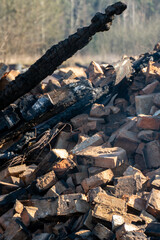 The consequences of a bomb explosion and a fire in a residential building in Ukraine during the war with Russia. The wreckage of a residential building, scattered things on the street, bricks