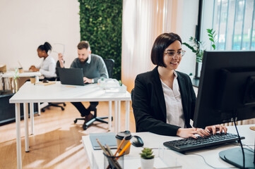 Business working on a computer in a creative office environment