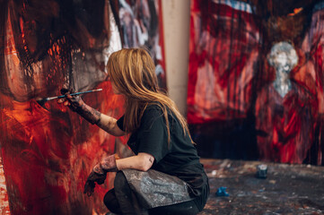 Female painter artist painting and creating her art in a creative studio