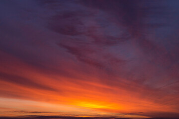 Fototapeta na wymiar Epic dramatic sunrise, sunset orange red pink clouds in sunlight on dark blue sky background texture 