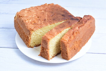 Homemade vanilla cake, displayed on plate and wooden background