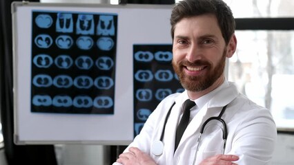 Medicine and healthcare concept. Proud smart male doctor, general medicine doctor, surgeon, radiologist, wearing glasses and medical uniform, standing in the clinic, looking at the camera, smiling