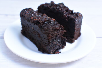 Traditional black ponque, with raisins, red wine flavor on wooden background