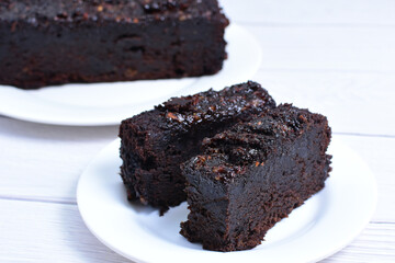 Traditional black ponque, with raisins, red wine flavor on wooden background