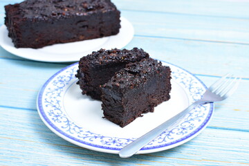 Traditional black ponque, with raisins, red wine flavor on wooden background