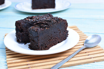 Traditional black ponque, with raisins, red wine flavor on wooden background