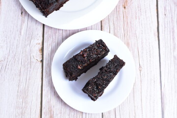 Traditional black ponque, with raisins, red wine flavor on wooden background