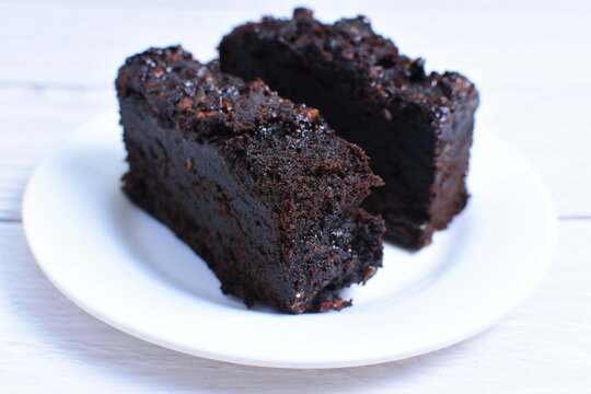 Traditional black ponque, with raisins, red wine flavor on wooden background