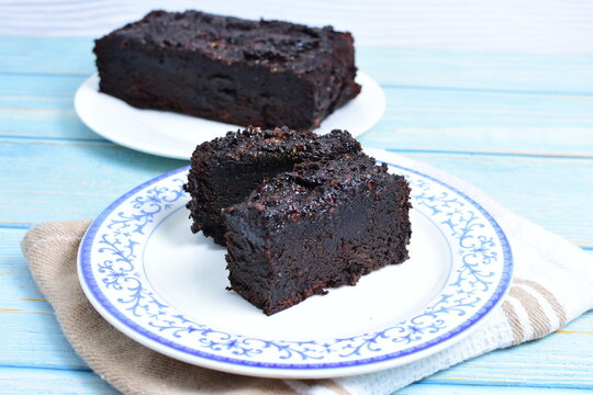 Traditional black ponque, with raisins, red wine flavor on wooden background