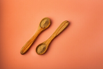 Maca powder in two wooden spoons - Lepidium meyenii.