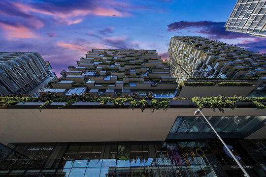 Apartment block in Sydney NSW Australia with hanging gardens and plants on exterior of the building at Sunset with lovely colourful clouds in the sky