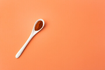 Capsicum annuum - Red chili powder or paprika in the ceramic spoon