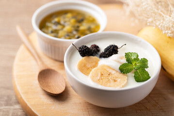 Yogurt with banana and mulberry in bowl, Healthy eating