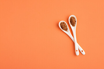 Crushed flax seeds in two ceramic spoons - Linum usitatissimum