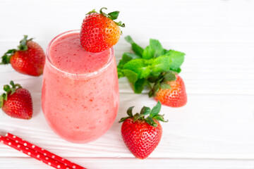 Strawberry yogurt fruit juice smoothie pink colorful fruit juice milkshake blend beverage healthy high protein the taste yummy In glass drink episode morning on white wood background.