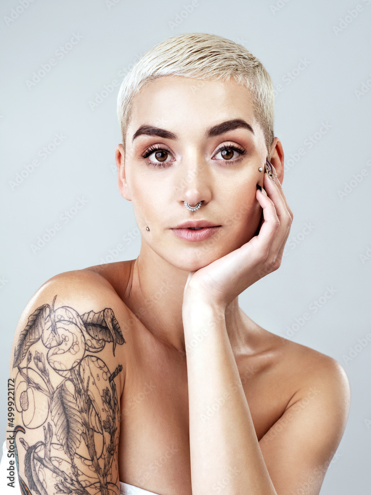 Sticker To be different is to be beautiful. Studio portrait of a beautiful young woman posing against a grey background.