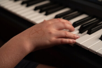Fototapeta na wymiar hands of a child playing the piano